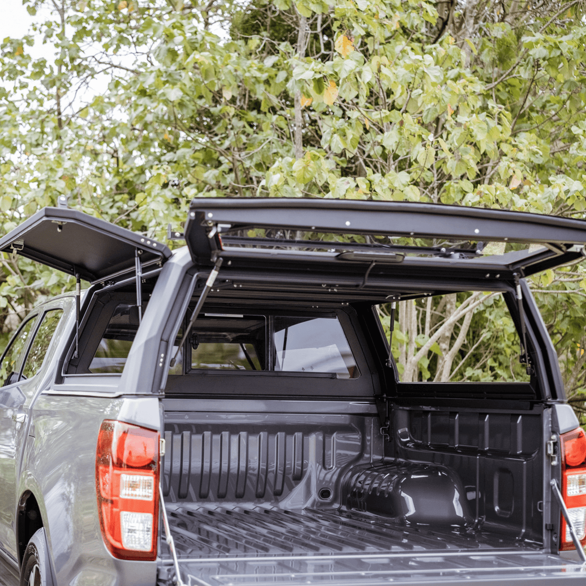 Inside the black Xpedition canopy on a Mazda BT-50 2021+, rear door open